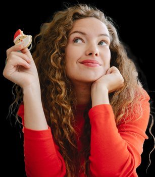 A woman delightedly considering a cookie